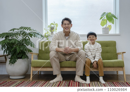 Portrait of a father in his 30s and a 7-year-old boy looking at the camera Portrait of a father in his 30s and a 7-year-old boy looking at the camera 110026984