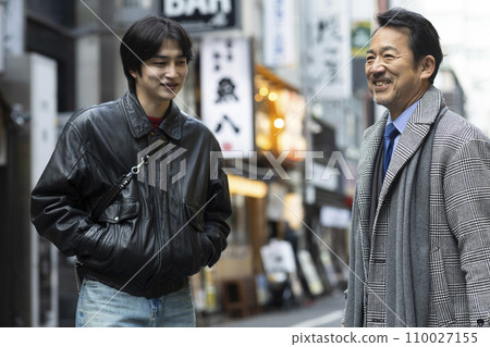 A man in his 50s goes out for a drink with his son. 110027155