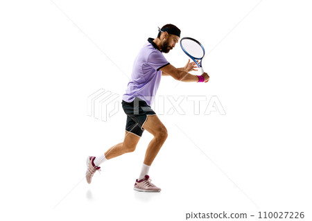 Concentrated competitive young man, tennis player in motion during game, playing isolated over white background. Sport, competition Concentrated competitive young man, tennis player in motion during game, playing isolated over white background. Sport, competition 110027226