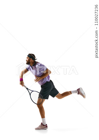 Full-length image of athletic young man, tennis player in motion with racket, practicing isolated over white background. Sport, competition Full-length image of athletic young man, tennis player in motion with racket, practicing isolated over white background. Sport, competition 110027236