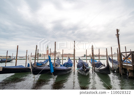 Gondola and Saint Mark square with San Giorgio di Maggiore church on background in Venice, Italy. 110028322