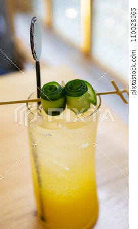 Tropical blush mocktail sweet and fresh drink with assorted tropical fruit mango and orange and soda. 110028965