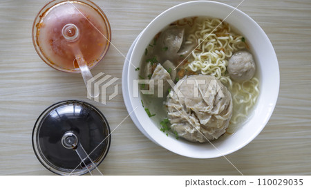 Indonesian famous foodstreet Bakso or baso is a meatballs served with the soup if beef broth, noodle, additional soy sauce and some chilli sauce. 110029035