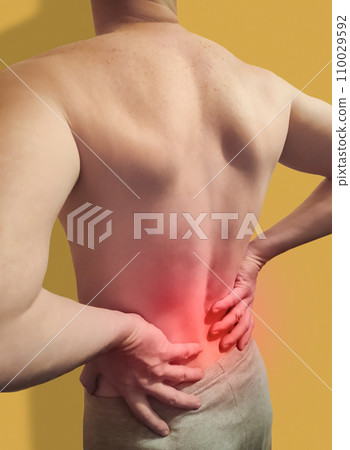 Lower back pain. Man holding his back in pain. Medical healthcare concept. 110029592