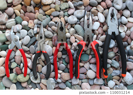 Slip Joint Pliers, Groove Pliers, Needle Nose Pliers And Linesman Pliers Laid Out Arranged On Size On A Stones Background Slip Joint Pliers, Groove Pliers, Needle Nose Pliers And Linesman Pliers Laid Out Arranged On Size On A Stones Background 110031214