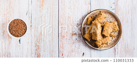 Pieces of halva with flax seeds on a plate on the table top view web banner Pieces of halva with flax seeds on a plate on the table top view web banner 110031333