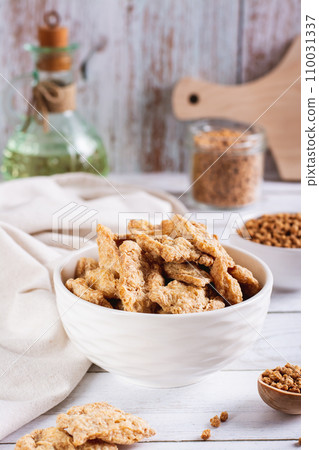 Dry dehydrated soy steaks and soy minced meat in bowls on the table vertical view 110031337