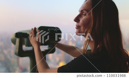 Woman enjoy Bangkok cityscape on Baiyoke Tower Sky viewpoint. Girl looking in binoculars telescope on observation deck for tourist. City skyline panorama at sunset. Travel, tourism, visit Thailand Woman enjoy Bangkok cityscape on Baiyoke Tower Sky viewpoint. Girl looking in binoculars telescope on observation deck for tourist. City skyline panorama at sunset. Travel, tourism, visit Thailand 110031986
