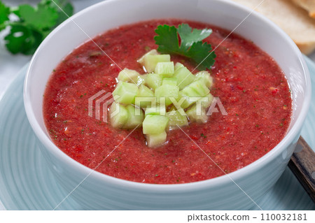 Gazpacho soup garnished with cucumber and cilantro, in bowl, horizontal Gazpacho soup garnished with cucumber and cilantro, in bowl, horizontal 110032181