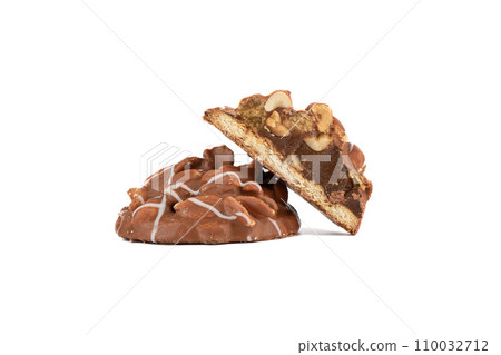Whole and half cookies with boiled condensed milk covered with nuts and chocolate icing. 110032712