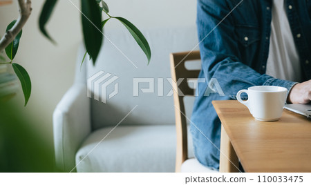 Middle-aged man operating a computer at home 110033475