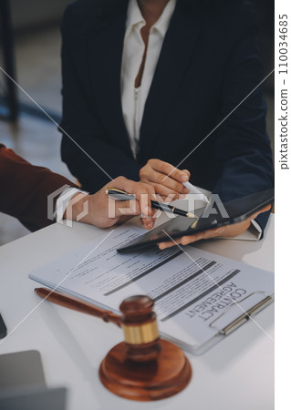 Lawyer, legal advisor, businessman brainstorming information on agreement details Business contracts in legal processing books for accuracy in contract documents. joint financial investment. 110034685
