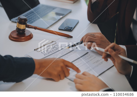 Lawyer, legal advisor, businessman brainstorming information on agreement details Business contracts in legal processing books for accuracy in contract documents. joint financial investment. 110034686