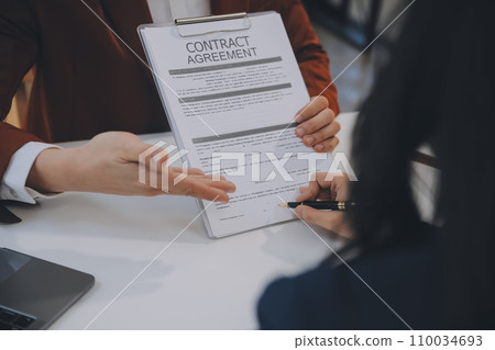 Lawyer, legal advisor, businessman brainstorming information on agreement details Business contracts in legal processing books for accuracy in contract documents. joint financial investment. 110034693