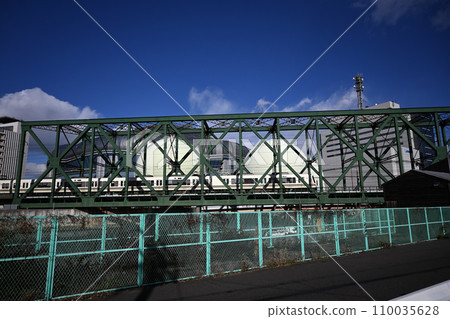 Rapid train crossing the iron bridge (Iwasaki Canal Bridge) 110035628