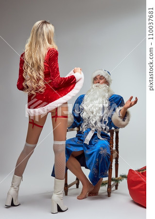 Erotic surprise for a Santa Claus in white studio Erotic surprise for a Santa Claus in white studio 110037681