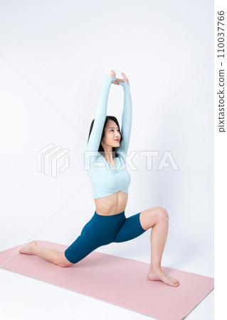 photo of a woman stretching bare body while sitting on a yoga mat photo of a woman stretching bare body while sitting on a yoga mat 110037766