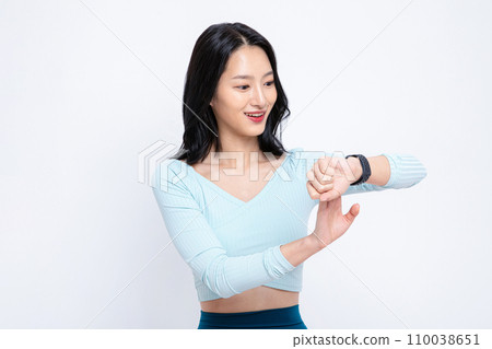 There is a woman looking at the watch. There is a woman looking at the watch. 110038651
