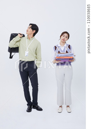 woman holding lots of documents and a man leaving work smiling with a bag woman holding lots of documents and a man leaving work smiling with a bag 110038685