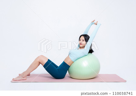 Health Beauty_woman stretching leaning on a gym ball 110038741