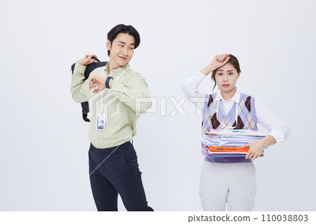 woman holding a lot of documents and a man leaving work smiling with a bag woman holding a lot of documents and a man leaving work smiling with a bag 110038803