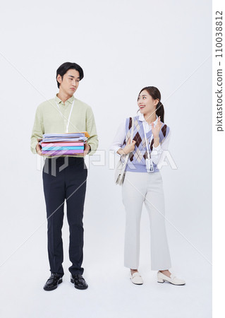 man holding a lot of documents and a woman leaving work laughing man holding a lot of documents and a woman leaving work laughing 110038812
