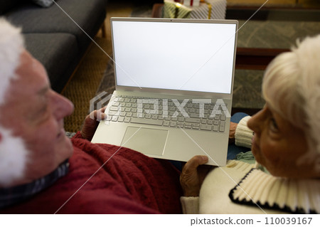 Happy caucasian senior couple in santa hats having christmas laptop video call, copy space on screen 110039167