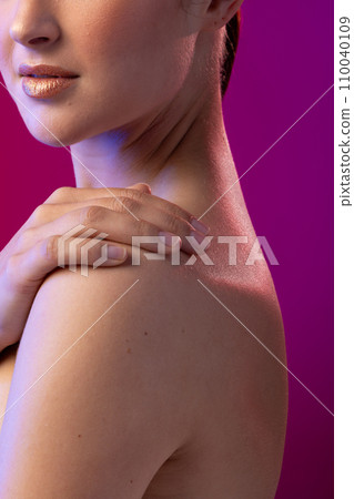 Caucasian woman wearing golden lipstick on purple background Caucasian woman wearing golden lipstick on purple background 110040109