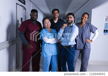 Portrait of happy diverse male and female doctors standing in hospital corridor Portrait of happy diverse male and female doctors standing in hospital corridor 110040691