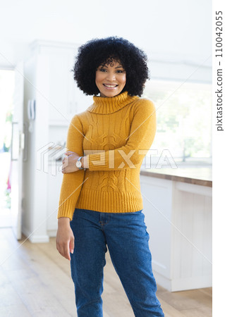 Happy african american woman standing holding hand at home, copy space 110042055