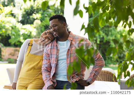 Happy african american couple embracing in sunny garden, copy space 110042175