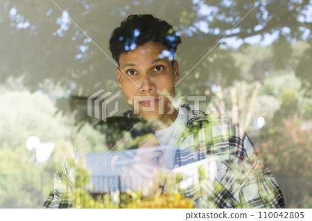 Happy diverse couple embracing and standing by window at home, copy space Happy diverse couple embracing and standing by window at home, copy space 110042805