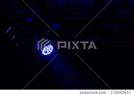 Stage LED spot light with blue beam in the dark 110043631