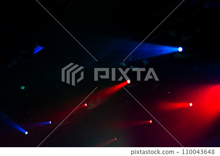Modern stage illumination. Colorful scenic spot lights glow in smoke Modern stage illumination. Colorful scenic spot lights glow in smoke 110043648
