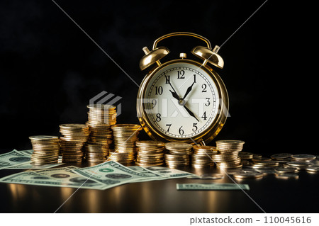 An image of stacked gold coins and a clock An image of stacked gold coins and a clock 110045616