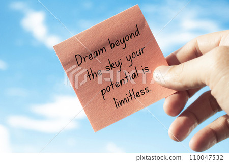 Motivational quote about dreaming beyond the sky on sticky note with sky background. Motivational concept. 110047532
