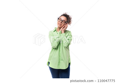 young charming brunette businesswoman with curly hair is dressed in an office light green shirt on a young charming brunette businesswoman with curly hair is dressed in an office light green shirt on a 110047775