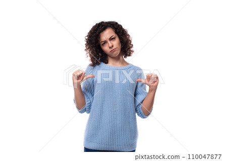 a slender young lady with black curly hair dressed in a light blue sweater is experiencing emotions a slender young lady with black curly hair dressed in a light blue sweater is experiencing emotions 110047877
