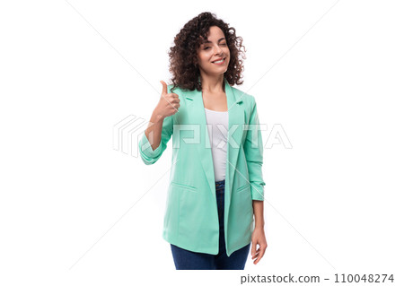 young stylish slim caucasian female model with curly shoulder-length black hair is dressed in a blue 110048274