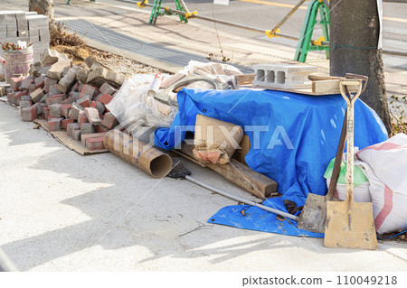 Bricks and tools placed at the construction site 110049218