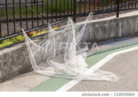 Garbage net tied to a fence 110050064