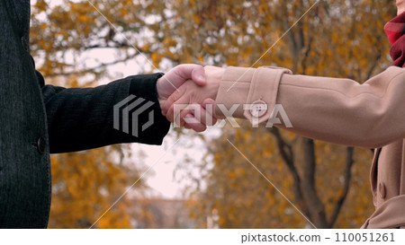 Man extends hand to woman as sign of agreement to maintain company at meeting 110051261