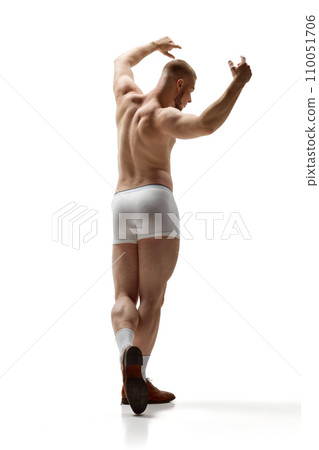 Full length portrait of naked man with healthy, muscled back posing raised hands up in underwear against white background. Full length portrait of naked man with healthy, muscled back posing raised hands up in underwear against white background. 110051706