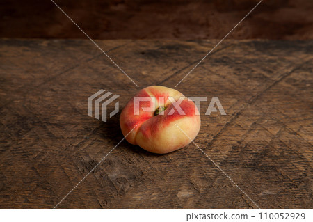 Saturn peach or flat peach on wooden background.. Saturn peach or flat peach on wooden background.. 110052929
