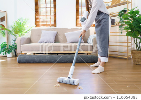 Hygiene cleaning concept, Housemaid use mop to mopping and cleaning dust on floor in living room 110054385