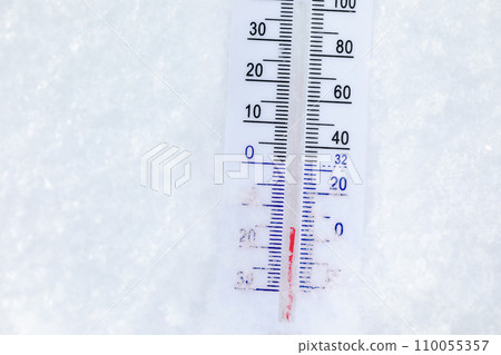 Outdoor thermometer in snow shows frigid winter temperature 110055357