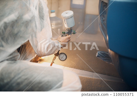 Car painter in protective clothes and respirator mask painting vehicle Car painter in protective clothes and respirator mask painting vehicle 110055371