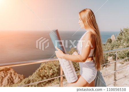 Fitness woman sea. Outdoor workout with fitness rubber bands in park over beach. Female fitness pilates yoga routine concept. Healthy lifestyle. Happy fit woman exercising with rubber band in park. 110056538