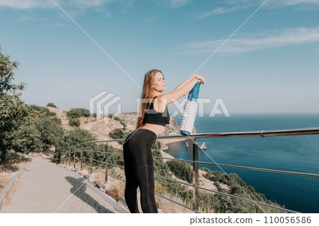 Fitness woman sea. Outdoor workout on yoga mat roller in park near to ocean beach. Female fitness pilates yoga routine concept. Healthy lifestyle. Happy fit woman exercising with rubber band in park. 110056586