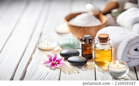 Beauty treatment items for spa procedures on white wooden table. massage stones, essential oils, sea salt, candles. 110056587